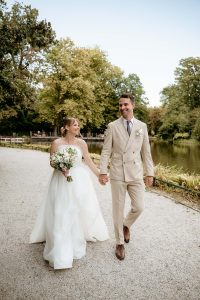 Bride and groom walking through Maksimir Park in Zagreb.